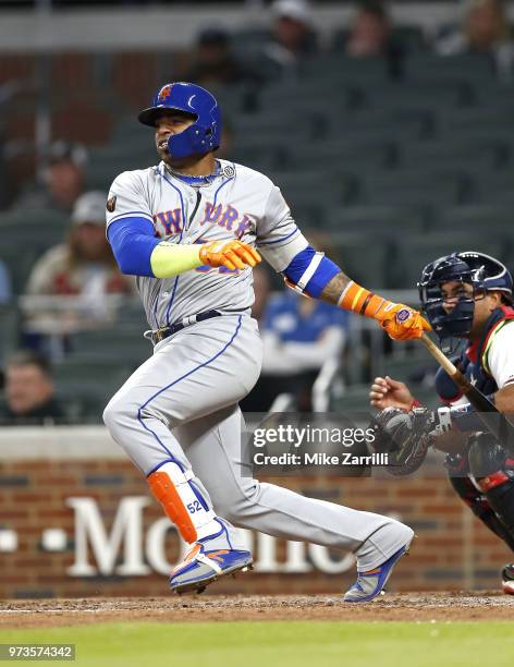 Left fielder Yoenis Cespedes of the New York Mets swings during the game against the Atlanta Braves at SunTrust Park on April 21, 2018 in Atlanta,...