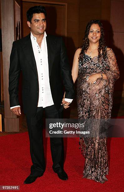 Bollywood actor Madhavan and his wife Sarita attend a party hosted by Indian businessman Anil Ambani and his actress wife Tina, February 28, 2010 in...