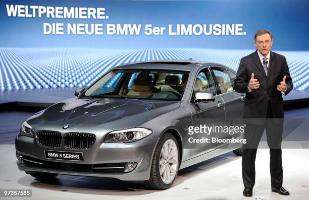 Norbert Reithofer, chief executive officer of Bayerische Motoren Werke , speaks next to a new BMW 5-Series automobile on the first press day of the...