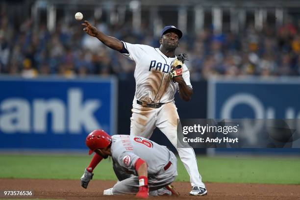 Jose Pirela of the San Diego Padres starts a double play at second base against Billy Hamlton of the Cincinnati Reds during the game at PETCO Park on...