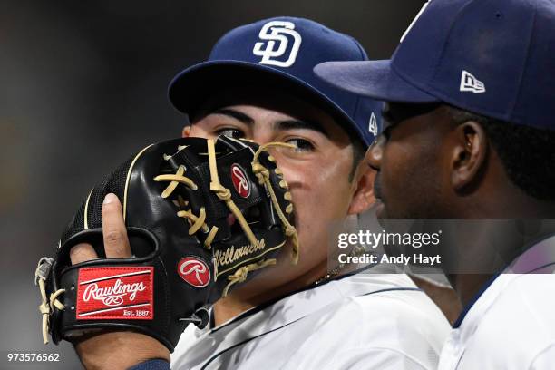 Christian Villanueva of the San Diego Padres talks to Jose Pirela as he leaves the field during the game against the Cincinnati Reds on June 2, 2018...