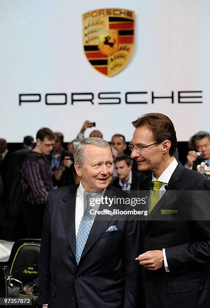 Michael Macht, chief executive officer of Porsche SE, right, poses with Wolfgang Porsche, chairman of the supervisory board of Porsche SE, on the...