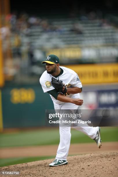 Yusmeiro Petit of the Oakland Athletics pitches during the game against the Seattle Mariners at the Oakland Alameda Coliseum on May 24, 2018 in...