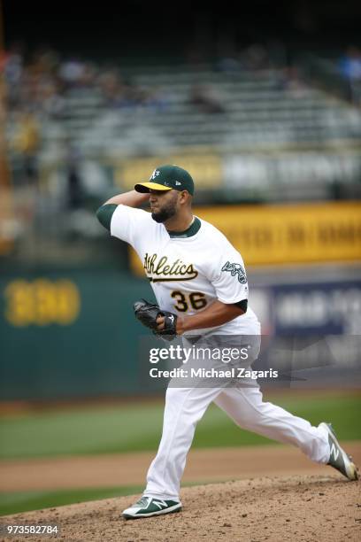 Yusmeiro Petit of the Oakland Athletics pitches during the game against the Seattle Mariners at the Oakland Alameda Coliseum on May 24, 2018 in...