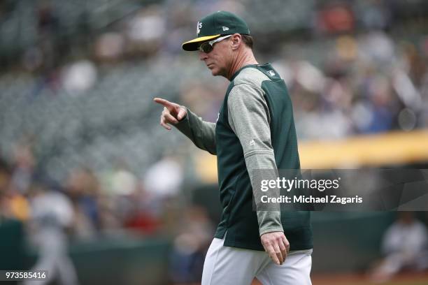 Manager Bob Melvin of the Oakland Athletics makes a call to the bullpen during the game against the Seattle Mariners at the Oakland Alameda Coliseum...