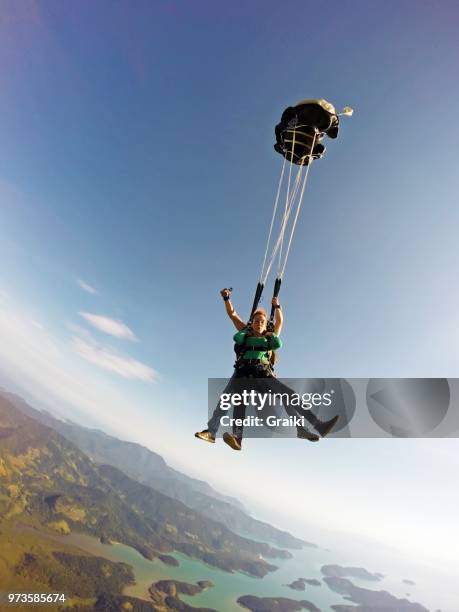 skydiving tandem opening the parachute - diving to the ground stock pictures, royalty-free photos & images