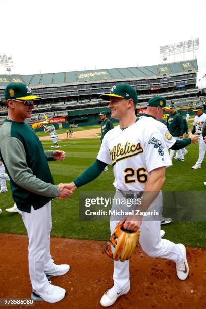 Manager Bob Melvin of the Oakland Athletics congratulates Matt Chapman on the field following the game against the Seattle Mariners at the Oakland...