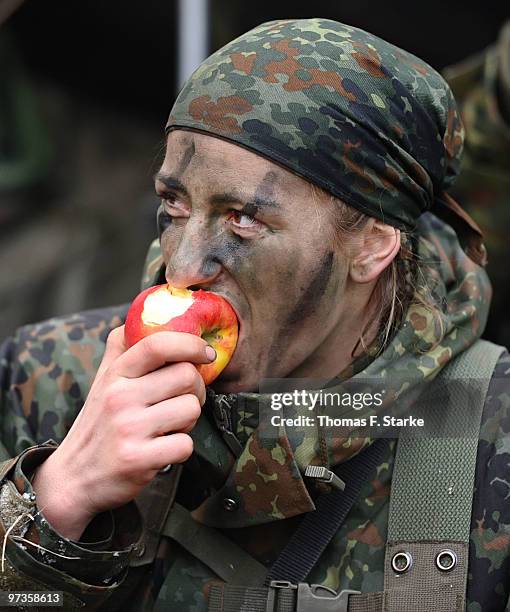 Bianca Schmidt eats an apple during a basic military service drill at the Clausewitz barrack on February 9, 2010 in Nienburg, Germany. German women's...