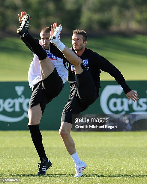 David Beckham warms up alongside Matthew Upson during an England training session at London Colney on March 2, 2010 in St Albans, England.