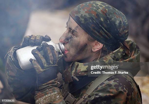 Bianca Schmidt drinks during a basic military service drill at the Clausewitz barrack on February 9, 2010 in Nienburg, Germany. German women's...