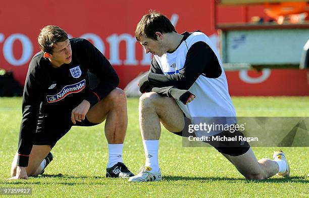 Stephen Warnock warms up alongside Leighton Baines during an England training session at London Colney on March 2, 2010 in St Albans, England.