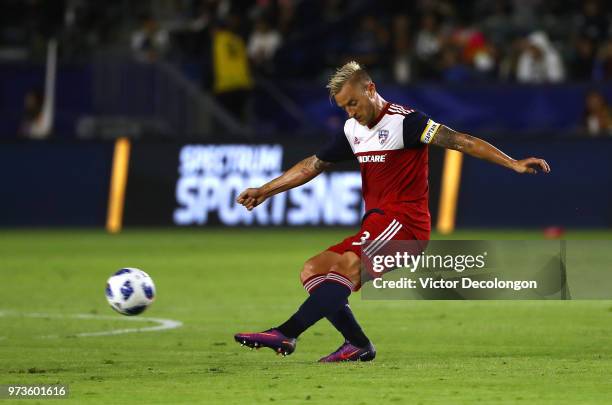 Reto Ziegler of FC Dallas chips a forward pass in the first half during the MLS match against the Los Angeles Galaxy at StubHub Center on May 30,...