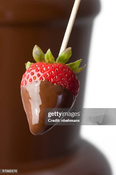 close up photograph of a strawberry dipped in milk chocolate - chocolate dipped stock pictures, royalty-free photos & images