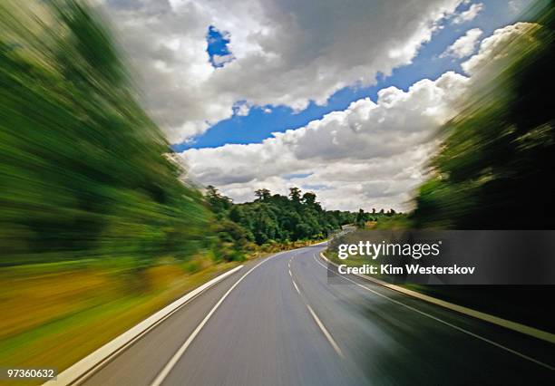tree-lined country road, sunlight and cumulus - westerskov stock pictures, royalty-free photos & images
