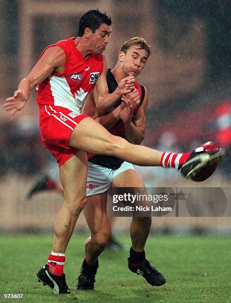 John Stevens of Sydney Swans kicks under pressure during the AFL trial match between the Sydney Swans and the Essendon Bombers at North Sydney Oval,...