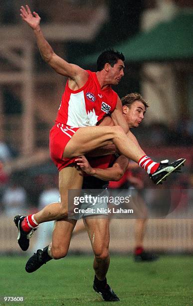 John Stevens of Sydney Swans kicks under pressure during the AFL trial match between the Sydney Swans and the Essendon Bombers at North Sydney Oval,...