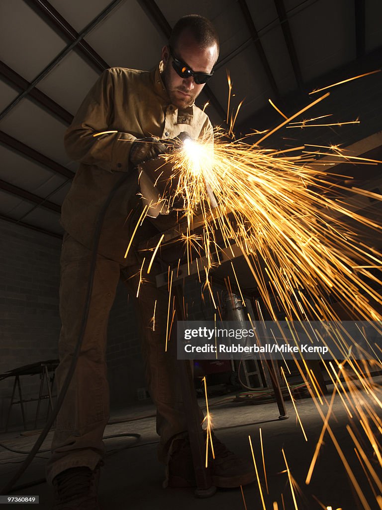 USA, Utah, Orem, man welding metal in workshop