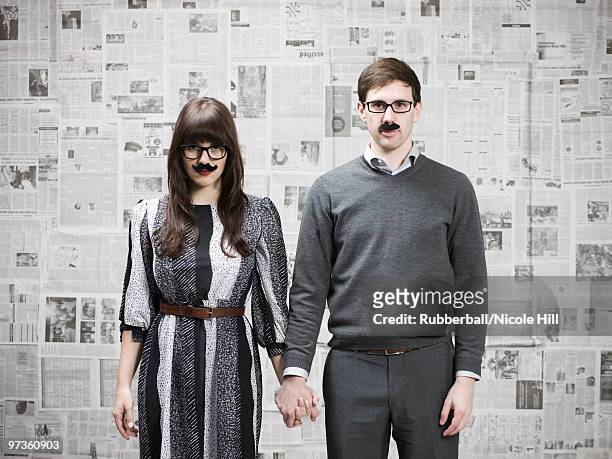 studio portrait of young couple wearing fake moustaches - groucho marx disguise stock pictures, royalty-free photos & images