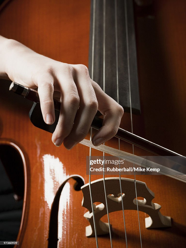 Close-up of young woman playing cello