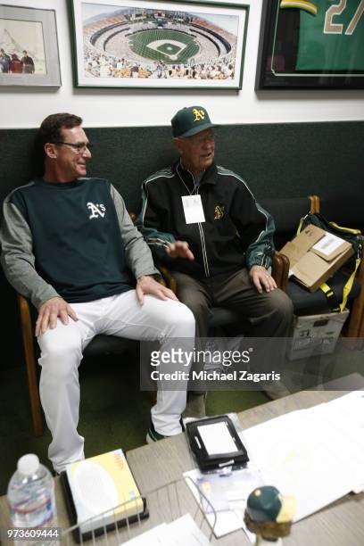 Manager Bob Melvin of the Oakland Athletics talks with Monte Moore in the clubhouse prior to the game against the Arizona Diamondbacks at the Oakland...