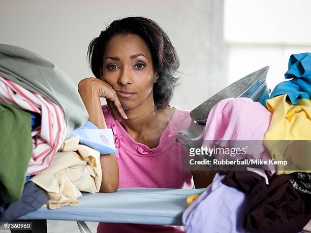orem, utah, usa, mid adult woman ironing - bored housewife 個照片及圖片檔