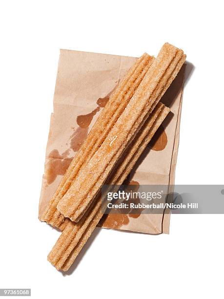 fresh churros on paper bag, view from above, studio shot - obesity epidemic stock pictures, royalty-free photos & images