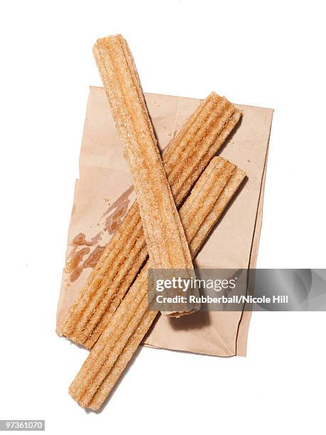 fresh churros on paper bag, view from above, studio shot - obesity epidemic stock pictures, royalty-free photos & images