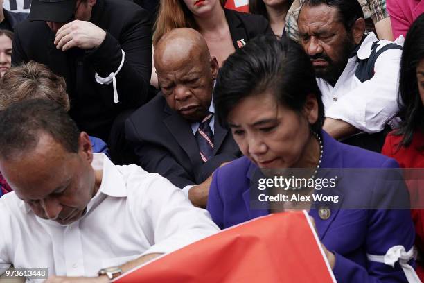 Rep. Judy Chu , Rep. Al Green , Rep. John Lewis and Rep. Luis Gutierrez participate in a moment of silence outside the headquarters of U.S. Customs...