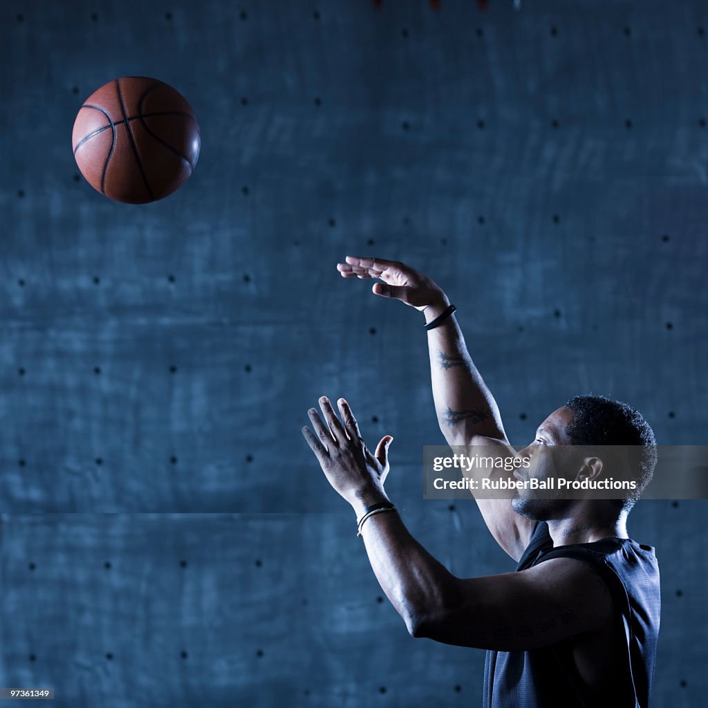 Studio shot of basketball player holding ball