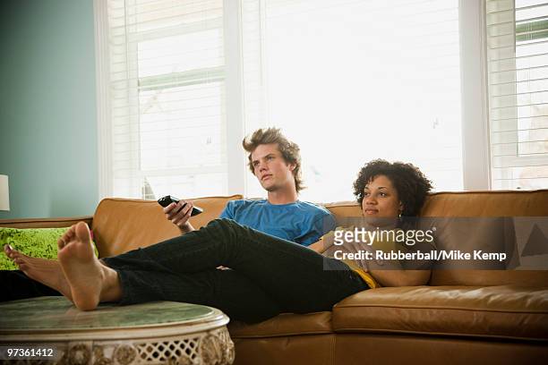 usa, utah, provo, couple sitting on sofa watching tv - bored girlfriend stock pictures, royalty-free photos & images