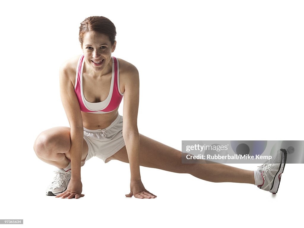 Young woman stretching, studio shot