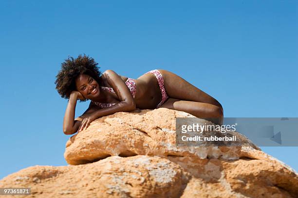 usa, utah, lake powell, young woman in bikini lying on rocks - reservoir model stock pictures, royalty-free photos & images