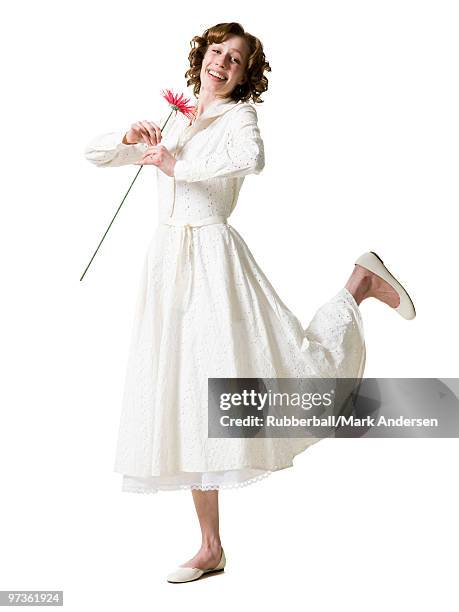 happy young woman dancing with gerbera flower, portrait, studio shot - dancing studio shot stock pictures, royalty-free photos & images