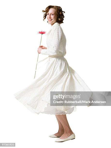 happy young woman dancing with gerbera flower, portrait, studio shot - dancing studio shot stock pictures, royalty-free photos & images