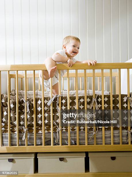 usa, utah, provo, baby boy (18-23 months) standing in crib - baby climbing stock pictures, royalty-free photos & images