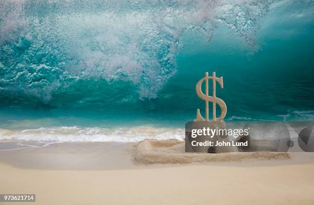 sandcastle dollar sign: impending financial and investment danger - impending danger stock pictures, royalty-free photos & images