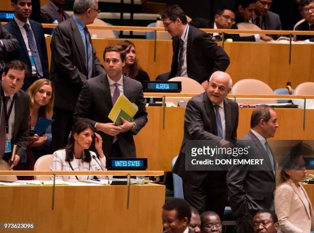 Palestinian Ambassador to the United Nations Riyad Mansour passes by US Ambassador Nikki Haley during voting, to condemn Israeli actions in Gaza, in...