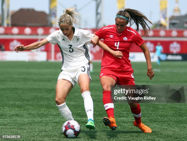 Kathrin Hendrich of Germany battles for the ball with Shelina Zadorsky of Canada during the first half of an International Friendly match at Tim...