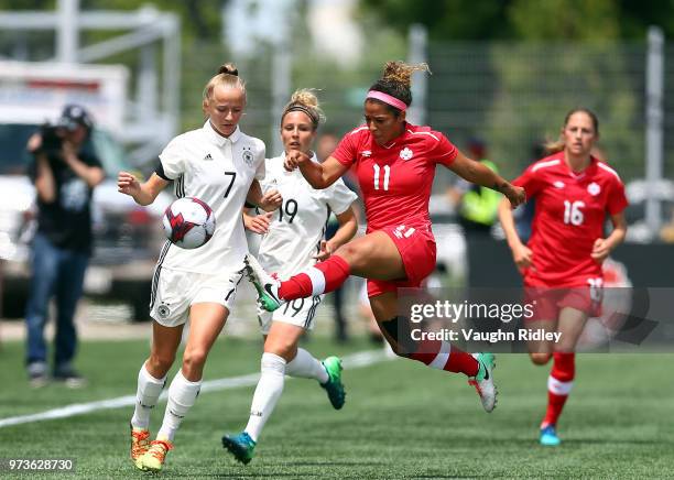 Lea Schuller of Germany is beaten to the ball by Desiree Scott of Canada during the first half of an International Friendly match at Tim Hortons...