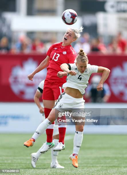 Leonie Maier of Germany and Sophie Schmidt go up for a header during the second half of an International Friendly match at Tim Hortons Field on June...