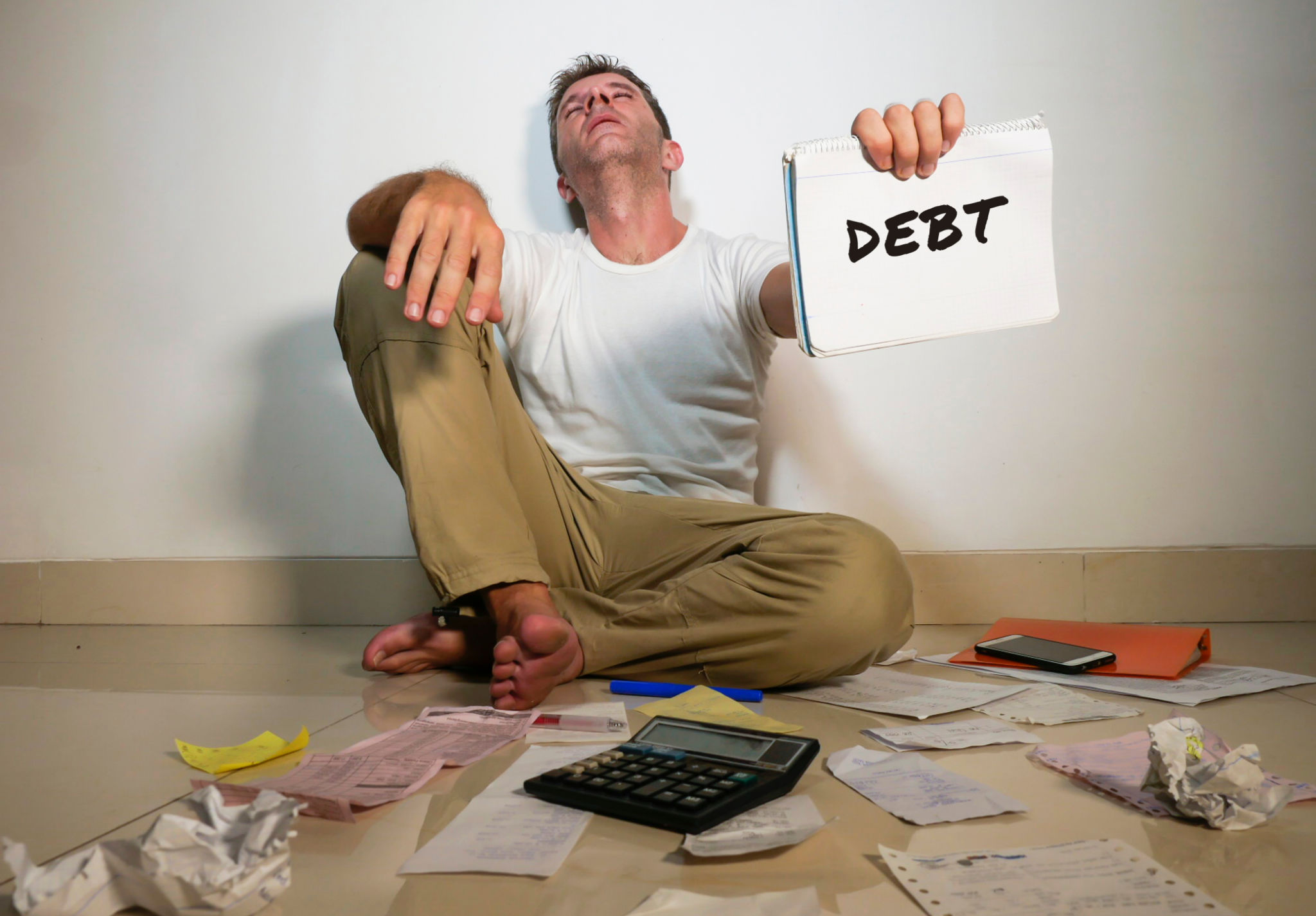 young desperate and stressed sad man worried holding calculator accounting domestic payments and debt having money problem sitting at home floor domestic finance lifestyle asking for help young desperate and stressed sad man worried holding calculator accounting domestic payments and debt having money problem sitting at home floor domestic finance lifestyle asking for help