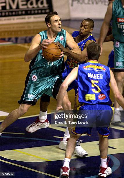 Jason Smith no 11 for Melbourne evades a tckle from Darnell Mee no 13 for Adelaide in the match between the Adelaide 36ers and the Melbourne Titans...