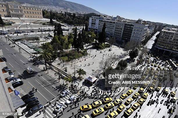 Greek taxi drivers block the Athens' Syntagma square during a 48-hour strike to protest against the debt-burdened government's fiscal reforms, in...