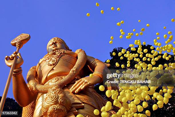 Yellow balloons are released during the unveiling of a statue of Lord Muruga in Batu Caves, Kuala Lumpur, 29 January 2006. The massive golden statue...