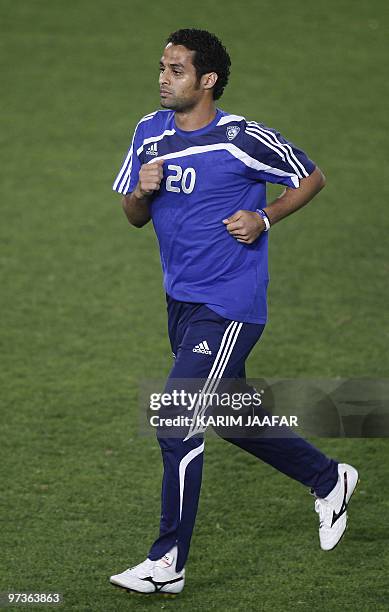 Saudi Al-Hilal club player Yasser al-Qahtani runs during a training session at the Al-Sadd stadium in Doha in preparation for their AFC Champions...