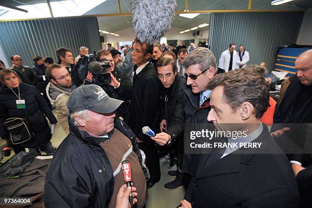 French President Nicolas Sarkozy , flanked by French Vendee county general council Philippe de Villiers and Junior Minister Transports Dominique...