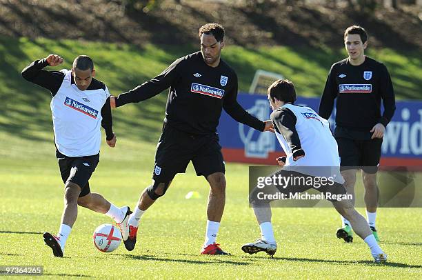 Theo Walcott, Joleon Lescott, Leighton Baines and Stewart Downing in action during an England training session at London Colney on March 2, 2010 in...