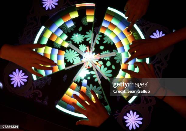 Children play a game on a touch-sensitive digital table at the Microsoft Digital Classroom at the CeBIT Technology Fair on March 2, 2010 in Hannover,...