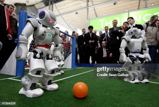 Robots play football in a demonstration of artificial intelligence at the stand of the German Research Center for Artificial Intelligence at the...