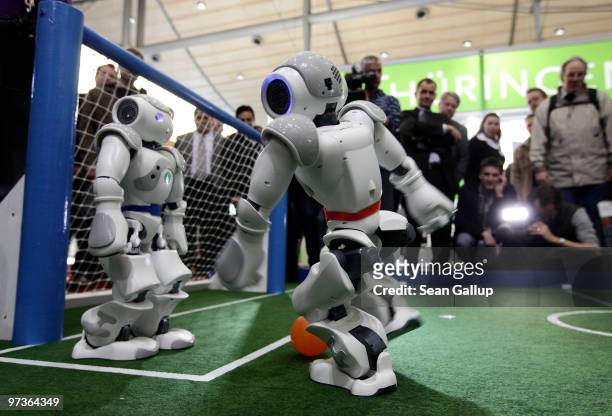 Robots play football in a demonstration of artificial intelligence at the stand of the German Research Center for Artificial Intelligence at the...
